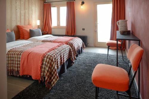 a hotel room with a bed and a chair at Chalet Nantailly in Hauteluce