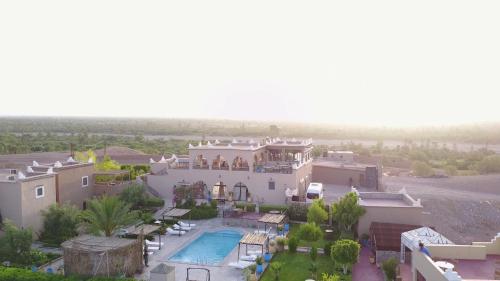 an aerial view of a large house with a swimming pool at Taloute Ecolodge in Skoura