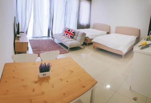 a living room with a table and a couch at Trefoil Setia Alam- Simple No 5- Near Setia City Mall & Convention Centre in Setia Alam