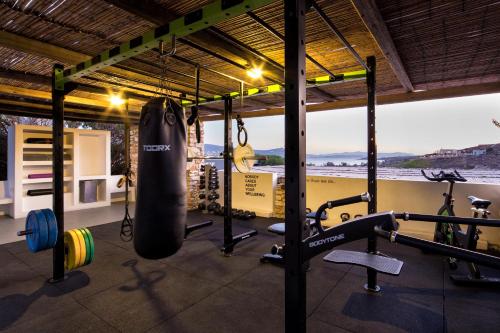 a fitness room with a gym with a punching bag and weights at Paros Agnanti Resort & Spa in Parikia