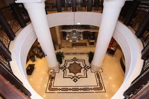 an overhead view of the lobby of a building with white columns at Al Hamra Hotel in Sharjah