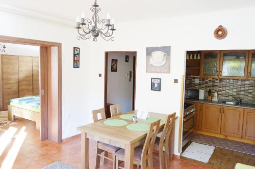 a kitchen and dining room with a table and chairs at Apartment Marta in Lipno nad Vltavou