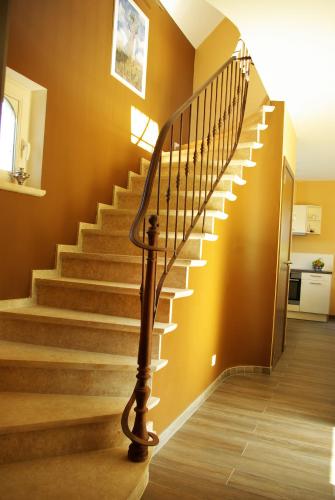 a spiral staircase in a home with brown walls at Charmes de Velupont with Wellness in Braives