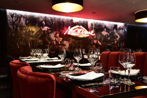 a restaurant with a long table with wine glasses at Maxime Hotel Lisbon in Lisbon