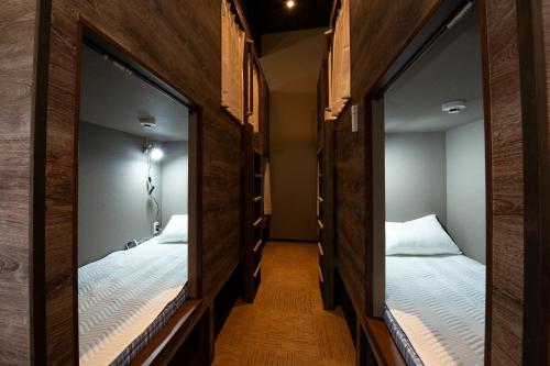 two bunk beds in a room with mirrors at bnbplus Sarasa Nara in Nara