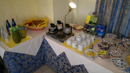 a table with food and drinks on top of it at Hotel Baia Del Sorriso in Castiglioncello