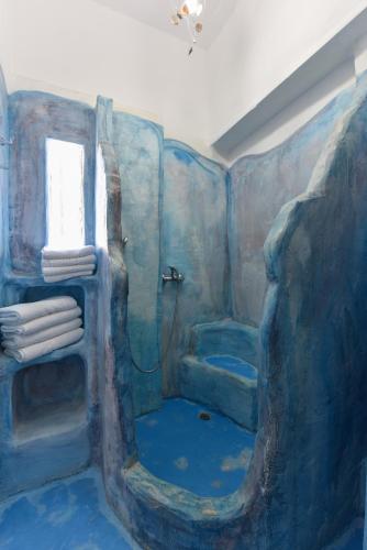 a painting of a bathroom with a shower at Giannakas Studios in Platis Yialos Sifnos