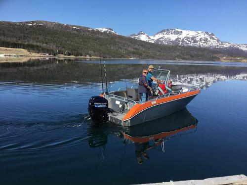 a couple of people on a boat in the water at Senja arctic lodge in Stonglandseidet