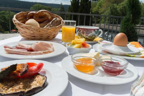 a table topped with plates of food and drinks at Hotel Kammerer in Sankt Georgen im Schwarzwald
