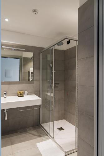 a bathroom with a shower and a sink at Hotel Domaso in Domaso