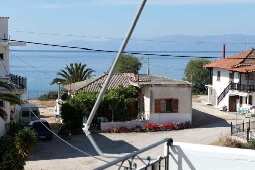 a view of a house with the ocean in the background at Sofia Apartments - Kantia in Kandia