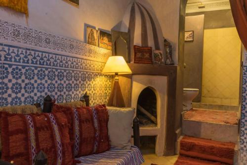 a living room with a couch and a fireplace at Riad Sidi Omar in Marrakesh