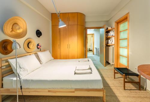 a bedroom with a large bed and a table at Kallimarmaro Residence in Athens