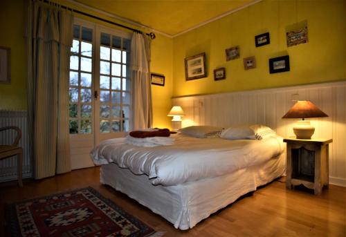 a bedroom with a large bed and a window at Maison Le Boubioz in Ugine