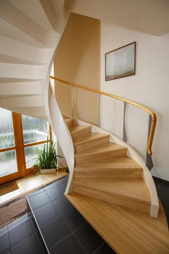 a spiral staircase in a house with a window at Domina in Vilnius
