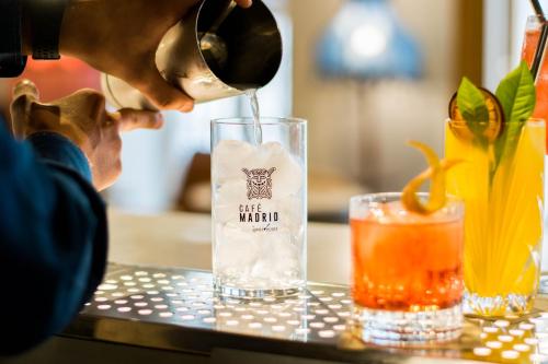 a person pouring a drink into a glass at MYR Marqués House in Valencia