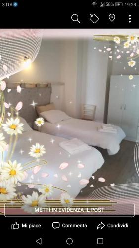 a picture of a bedroom with two beds with flowers at Belvedere dei monti Dauni di Castelluccio valmaggiore in Castelluccio Valmaggiore