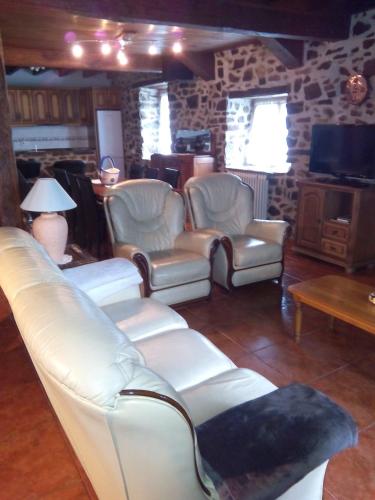 a living room with a couch and chairs and a tv at Casa Manuelena in Valcarlos