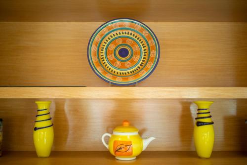 a shelf with three vases and a plate on it at Best Western Centro Monterrey in Monterrey