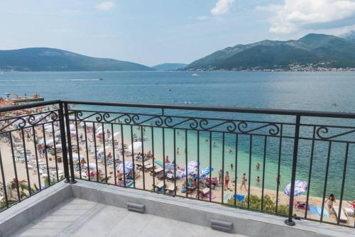 a view of a beach with people in the water at " Tiamat " apartmani in Tivat
