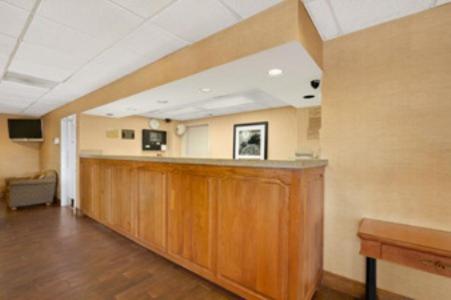 an empty room with a bar in a hospital at Super 8 by Wyndham Oxford in Oxford