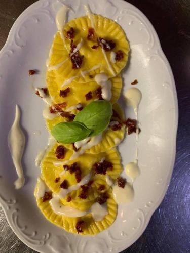 a white plate with a piece of food on it at Agriturismo Albero del Latte in Bagnolo San Vito