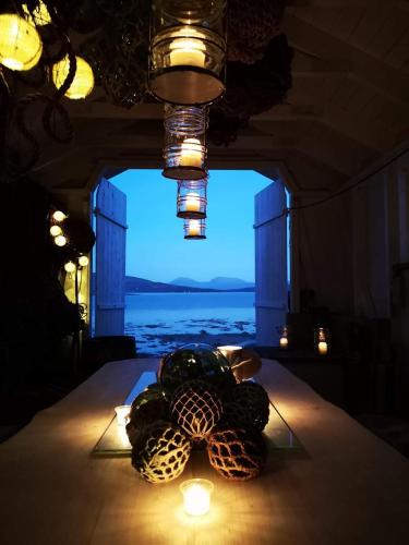 a table with some candles on it with a window at Norwegian Wild in Vangsvik