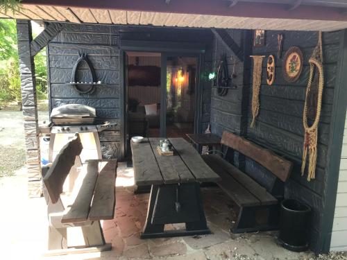 a patio with a wooden bench and a table at SKRZAT in Tumlin