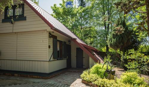 a small house with a porch and a door at SKRZAT in Tumlin