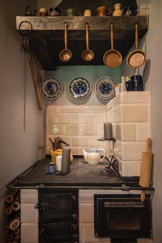 a kitchen with plates and utensils on the wall at SKRZAT in Tumlin