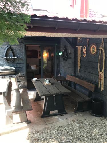 a picnic table in front of a cabin at SKRZAT in Tumlin