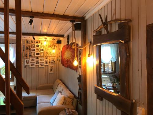 a living room with a couch and a mirror at SKRZAT in Tumlin