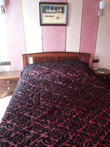 a large bed in a bedroom with a large bedspread at Studio avec piscine à Mirador cabo négro in Cabo Negro
