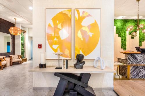 a desk in a lobby with a painting on the wall at Riverwalk Plaza Hotel in San Antonio