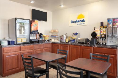 a restaurant with two tables in front of a counter at Days Inn by Wyndham Eureka CA in Eureka