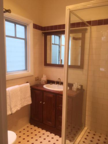 a bathroom with a sink and a shower at House on the Hill Bed and Breakfast in Huonville