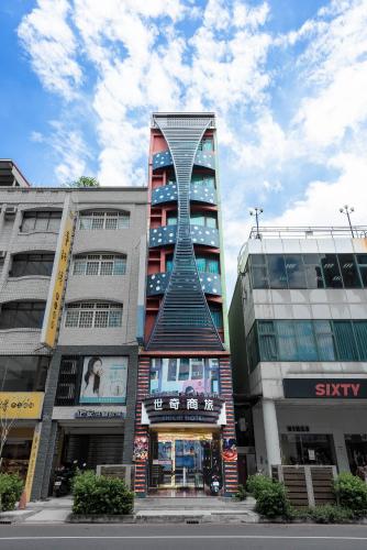 a tall building with a spiral tower in a city at Shichi Hotel in Kaohsiung