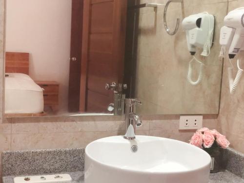 a bathroom with a white sink and a phone at 1949 Dreamy Home in Panglao