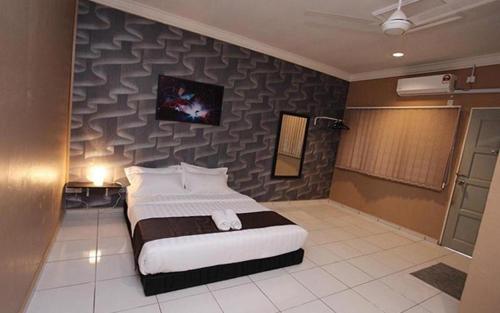 A bed or beds in a room at NDE Hotel