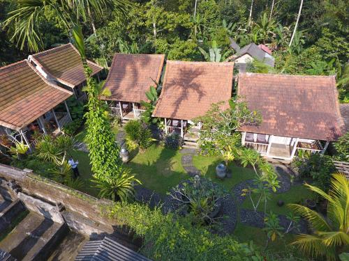 an aerial view of a group of houses with trees at De Umah Bali Eco Tradi Home in Bangli