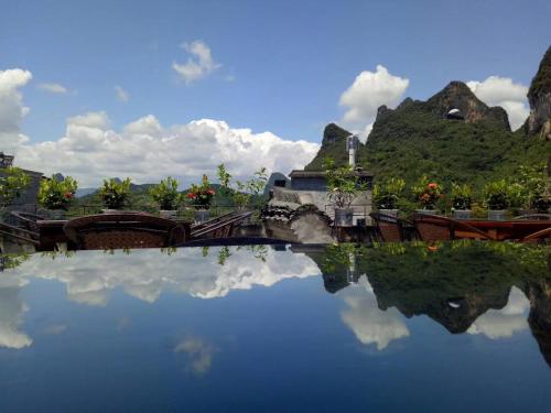 a reflection of a train in a body of water at Yangshuo Village Inn Boutique Hotel in Yangshuo