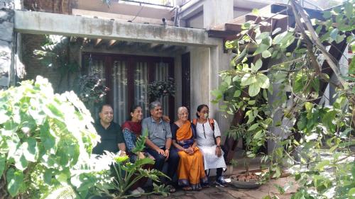 a group of people sitting outside of a building at Villa Tulip Garden in Anuradhapura