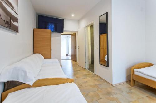 a bedroom with two beds and a mirror at Gösserhof in Leoben