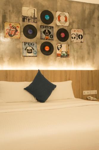 a bedroom with a bed with records on the wall at HOTEL CIQ, JALAN TRUS in Johor Bahru