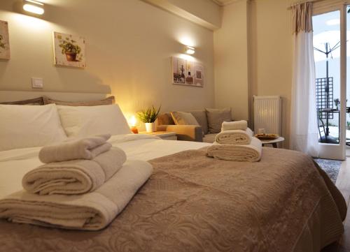 a bedroom with a bed with towels on it at Studio Posh with garden in Kolonaki in Athens
