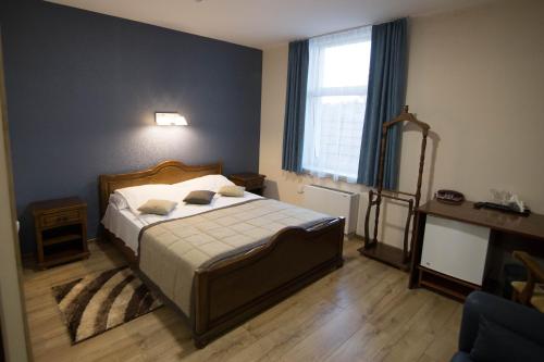 a bedroom with a bed and a large window at Hotel Villa Natali in Chişinău