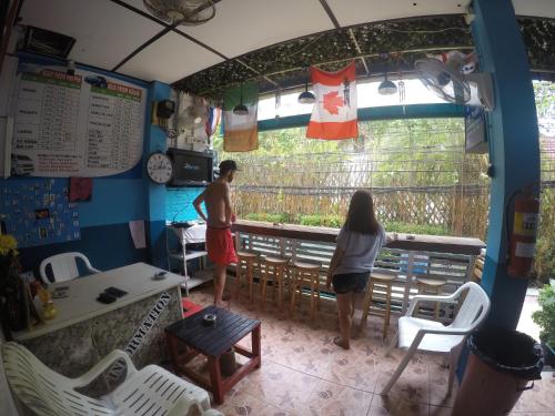 a man and a woman standing at a bar at Rehab Hostel in Phi Phi Islands