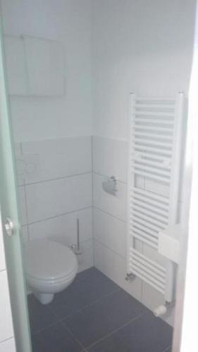 a white bathroom with a toilet and a sink at Gästehaus Hosp in Reutte