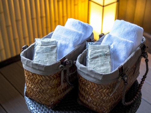 two baskets filled with towels on top of a table at Suiun in Hakone