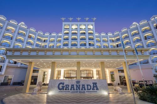 a large building with a sign in front of it at Granada Luxury Belek - Family Kids Concept in Belek